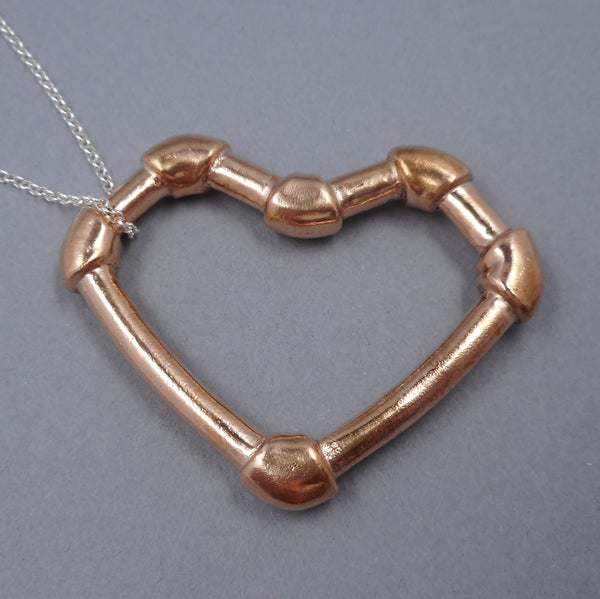 Pink silver industrial heart pendant from Forged Mettle Jewelry