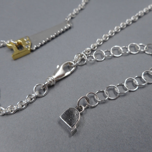 Lobster Claw Clasp and Tape Measure Charm of Saw Necklace from Forged Mettle Jewelry