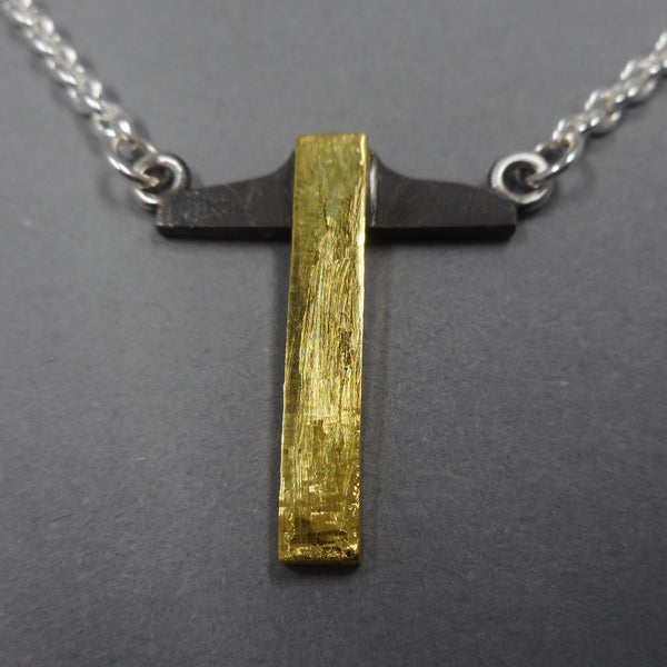 Close up of 22k gold version of t-square necklace from Forged Mettle Jewelry